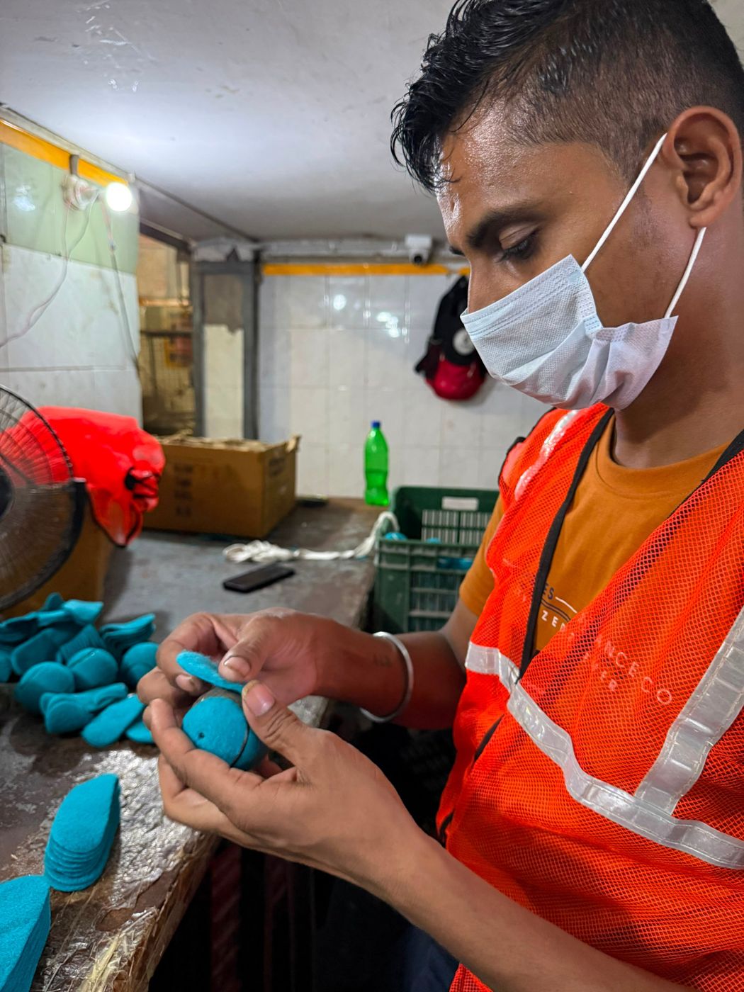 Worker pasting felt onto a ball core by hand
